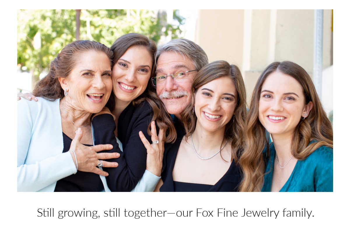 Fox Family with Debbie, Karen, George, Charlotte, and Niki posing together. With text reading 'Still growing, still together—our Fox Fine Jewelry family.'