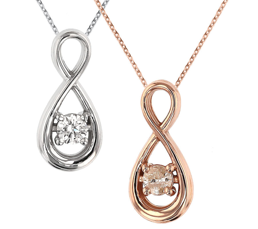 Two infinity style necklaces with a diamond in each: one in white gold and one in rose gold.