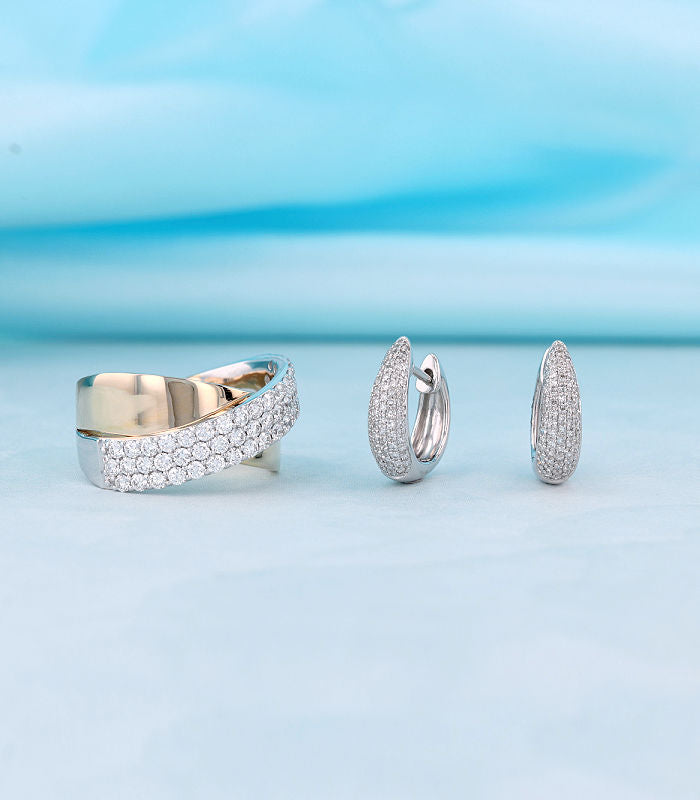 Pave set two tone ring and pave set white gold huggie hoop earrings. Both with small diamonds.