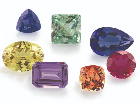 Sapphires and lab grown sapphires shown in all colors of the rainbow in different shapes and sizes.