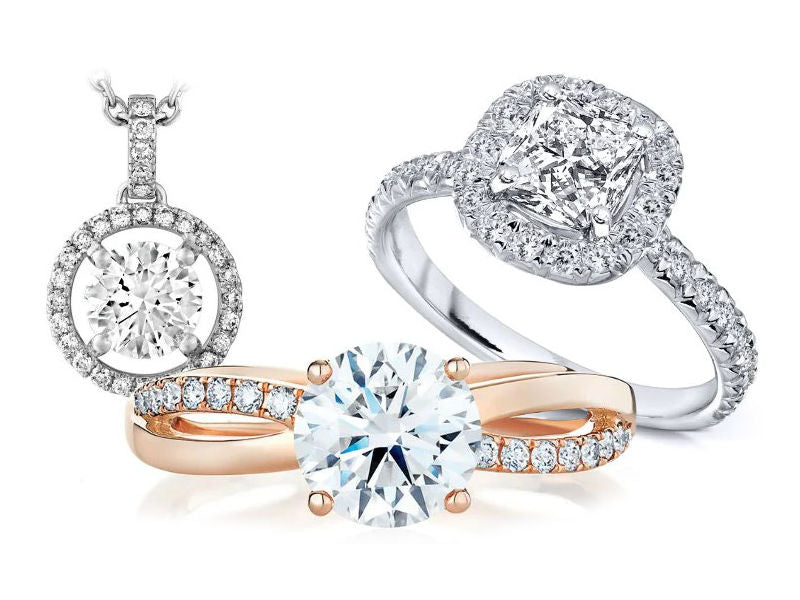 Two diamond engagement rings and a diamond halo pendant