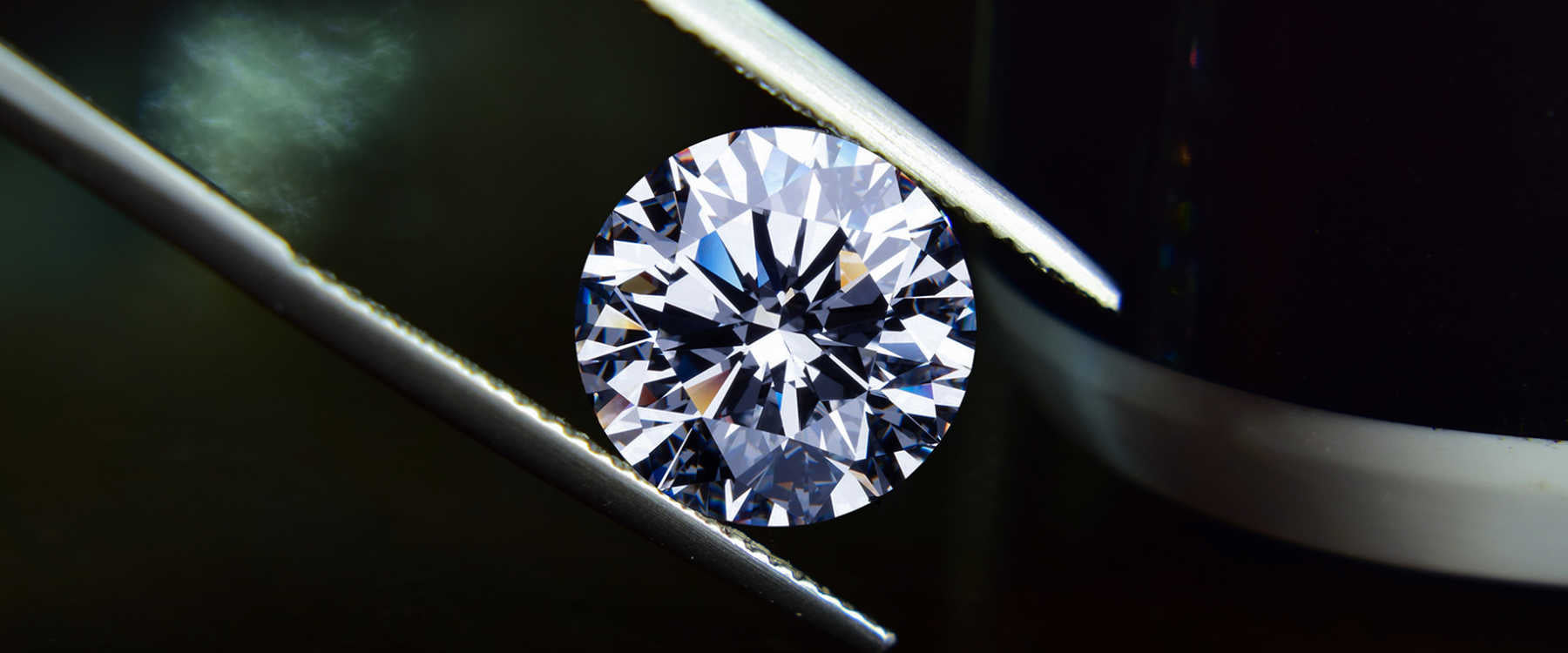 A diamond being held by tweezers