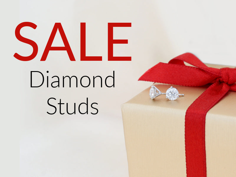 Diamond stud earrings on a gift box with a red ribbon, surrounded by 'SALE Diamond Studs' text.