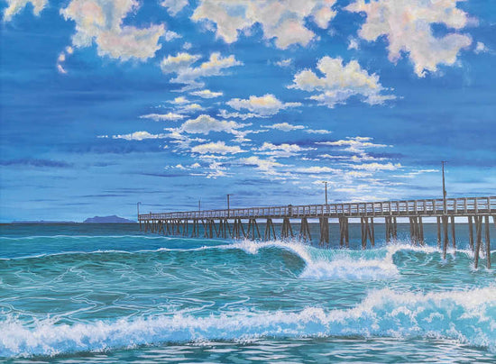 A painted seascape showing turquoise ocean waves with white foam, a long wooden pier extending into the water, and a bright blue sky filled with white clouds. Hueneme Pier by Zrondeb