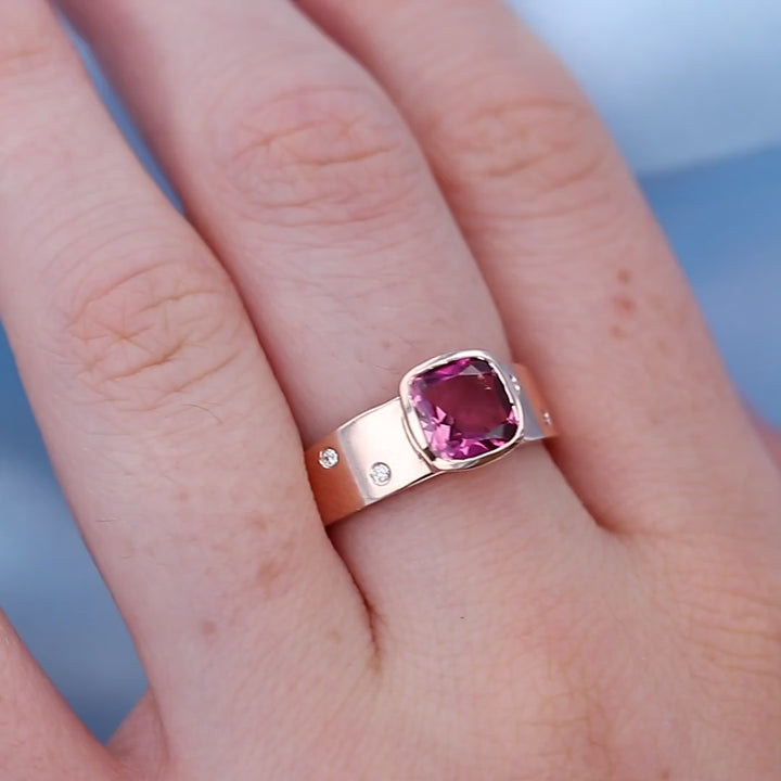 Bezel Set Pink Tourmaline Ring on a Finger