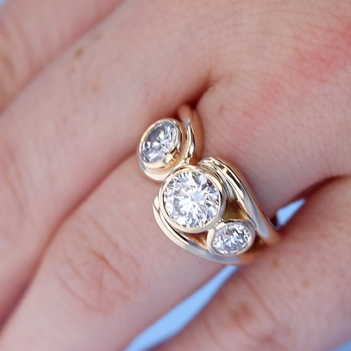 Organic Three Stone Bezel Set Diamond Engagement Ring on a Finger
