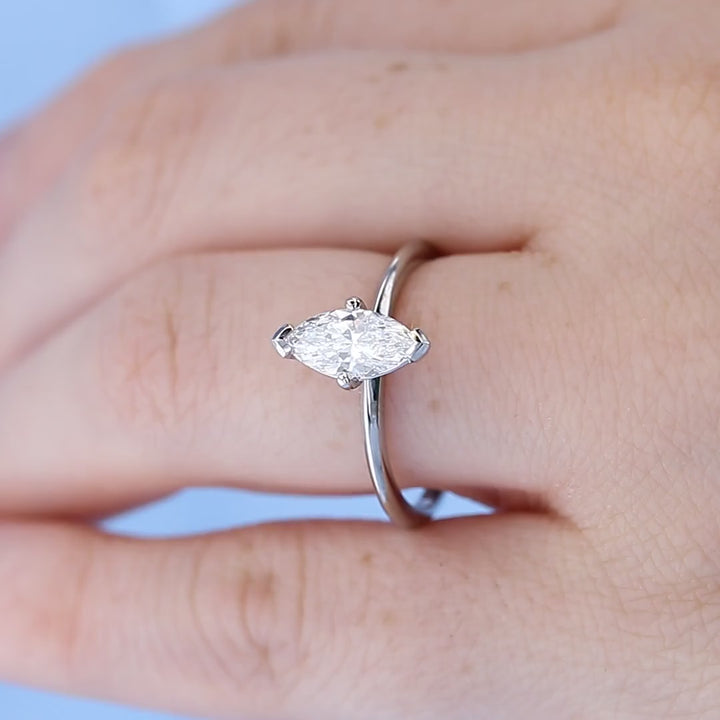 Platinum Solitaire Marquise Diamond Engagement Ring on a Finger