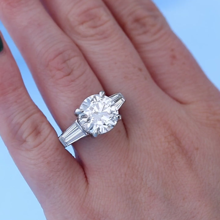 Three Stone Platinum Baguette Diamond Engagement Ring on a Finger