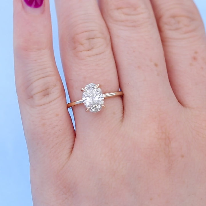 Oval Solitaire Diamond Engagement Ring on a Finger