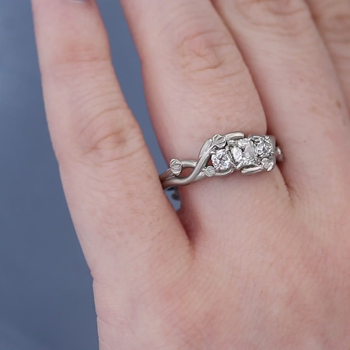 Three Stone Organic Diamond Engagement Ring on a Finger