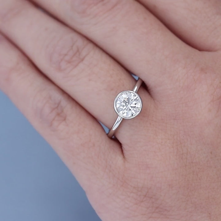 Bezel Set Solitaire Diamond Engagement Ring on a Finger