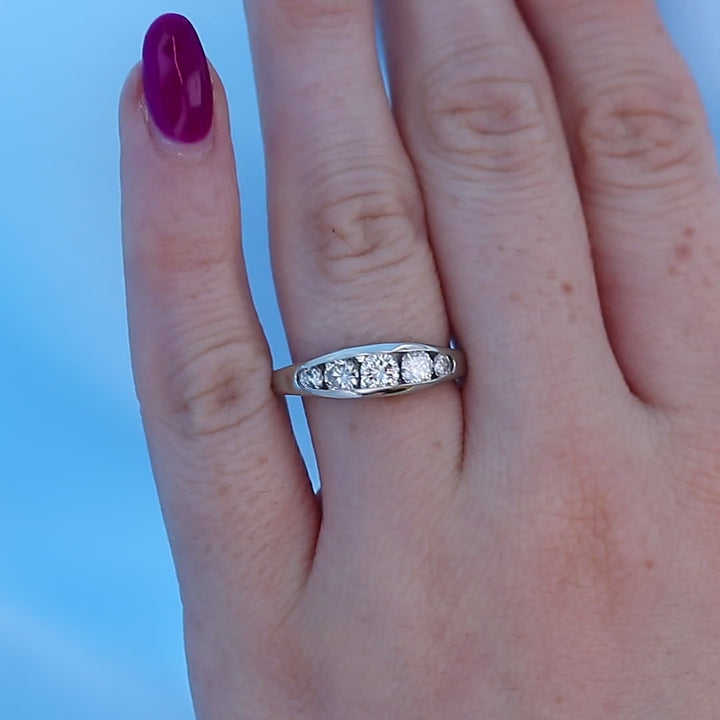 Tapered Channel Set Diamond Wedding Band on a Finger