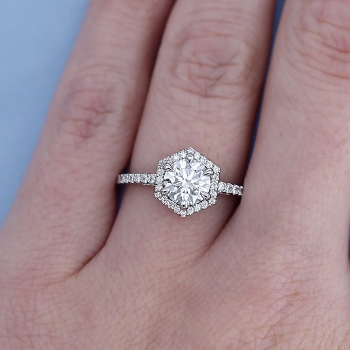 Platinum Hexagon Halo Diamond Engagement Ring on a Finger
