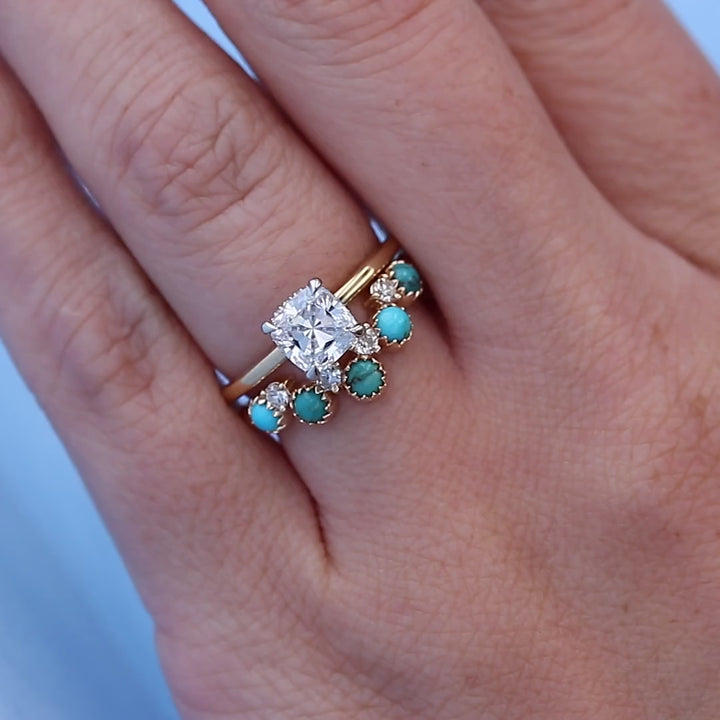 Turquoise & Diamond Contour Wedding Band on a Finger with a Hidden Halo Cushion Engagement Ring