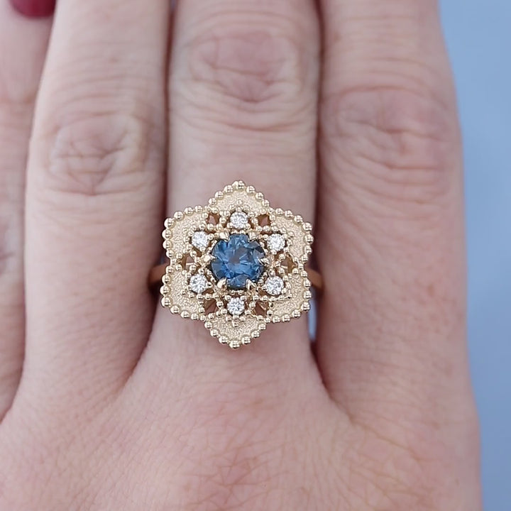 Sapphire & Diamond Flower Halo Ring on a Finger