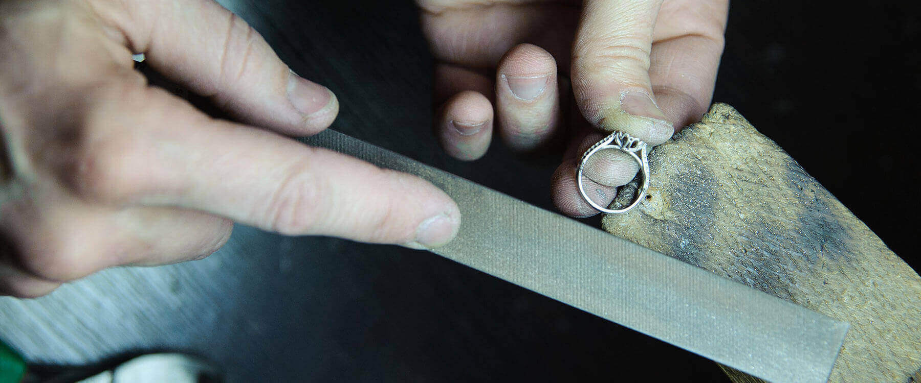 A ring being filed at a work bench