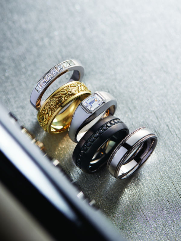 Men's rings in different metal types, including white gold, yellow gold, platinum, two tone, and a black contemporary metal