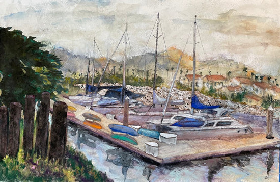 Marina scene with boats docked at a pier, surrounded by greenery and buildings. Ventura Yacht Club by Lisa Sachs