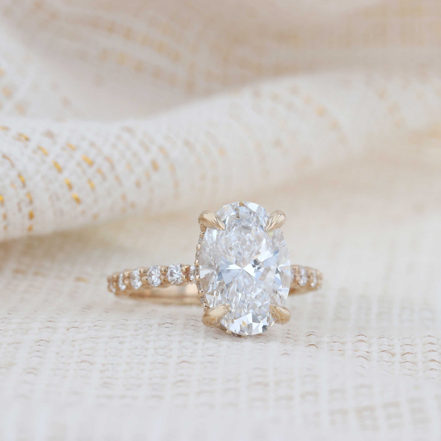 Hidden Halo Oval Diamond Engagement Ring on Fabric