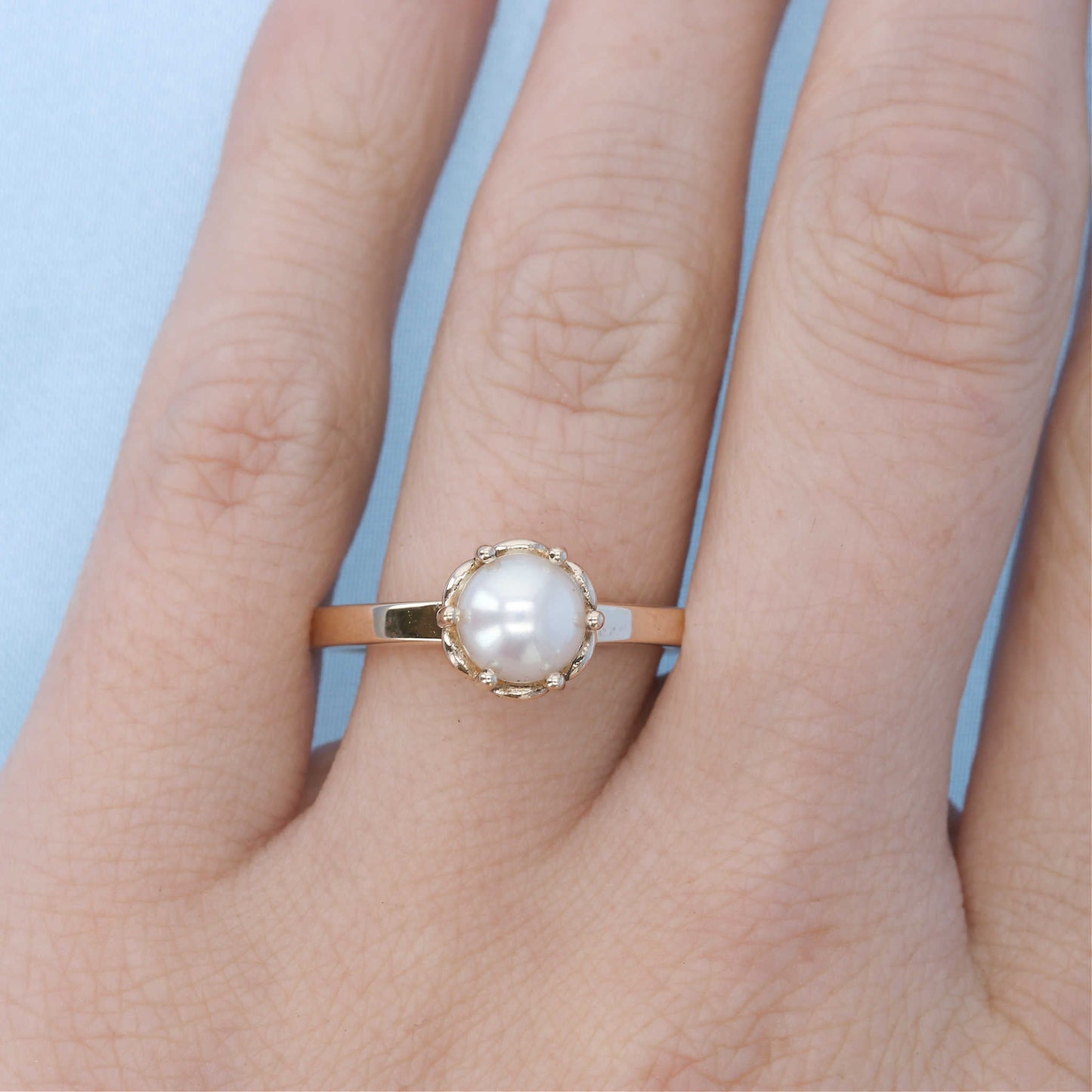 Pearl Solitaire Ring on a Finger