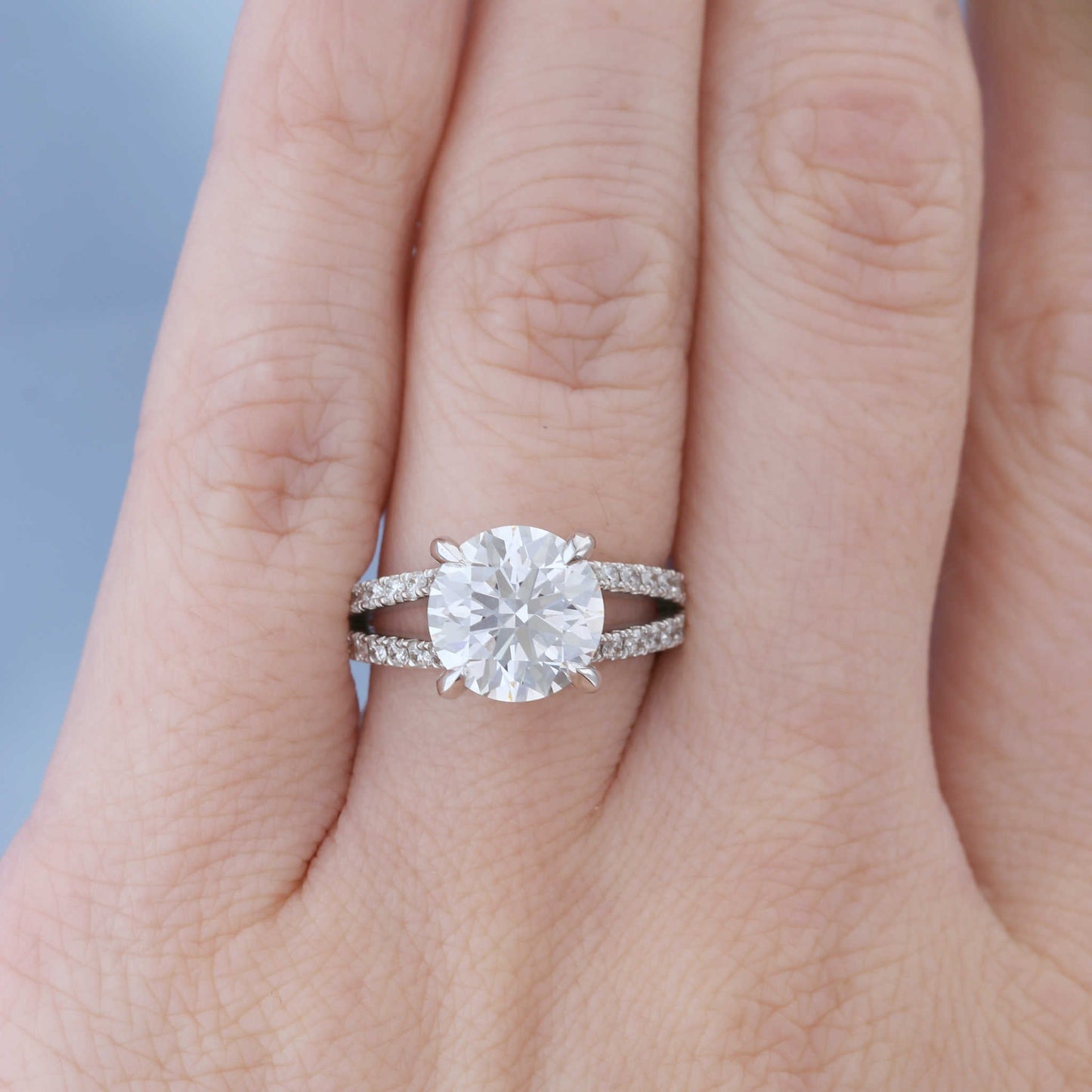Split Shank Hidden Halo Diamond Engagement Ring on a Finger