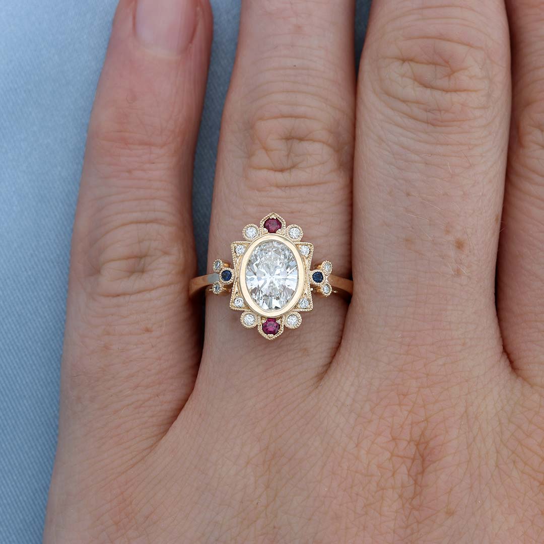 Vintage Ruby & Sapphire Halo Oval Diamond Engagement Ring on a Finger